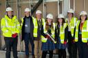 A time capsule has been buried at Castle School (L-R) - Will Corry from Morgan Sindall, Chris Hughes from CSET, Andy Bethell from Castle School, head students Vicky Johnson and Jessica Mallet, headteacher Jess Lobbett and Rachael Squire from Castle