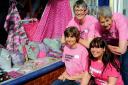 Breast Cancer Awareness volunteers Sue Davies, Maggie Butterfield, Sue Parry and Megan Parry with the heart-shaped cushions in the window of Inches in Dursley
