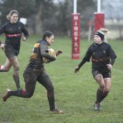 Polly Pearce charges through the rain for her first try