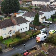 Police at the scene where three children were found dead at a property on Sunday - photo by PA