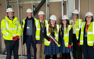 A time capsule has been buried at Castle School (L-R) - Will Corry from Morgan Sindall, Chris Hughes from CSET, Andy Bethell from Castle School, head students Vicky Johnson and Jessica Mallet, headteacher Jess Lobbett and Rachael Squire from Castle