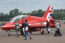 Photograph of a Prince William, Kate and Prince George next to a RAF Red Arrows plane taken by Chris Roberts