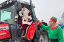 Santa swaps sleigh for tractor at snowy Christmas party