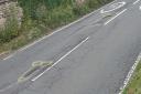 Rude markings have appeared around potholes in Rodborough Hill, Stroud. FREE TO USE FOR ALL PARTNERS. CREDIT: LDRS