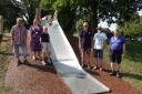Councillors and staff by the new slide in Woodchester Park with local resident Isla