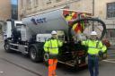 From left. Highways manager Max Kelly and cabinet member Dom Morris with a spray injection patcher outside Shire Hall