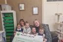 Children and staff from Severn Beach Preschool celebrating its £1,500 donation from the Moto Foundation