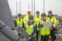 Yate mayor Cllr Cheryl Kirby placing the final roof tile on Ladden View as part of the ceremony with other representatives