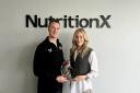 Nutrition X co-directors James Markey and Naomi Christiansen celebrate the recent award win