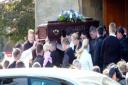 The coffin leaving the church
