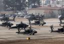 US Army Apache helicopters take off at Camp Humphreys in Pyeongtaek, South Korea (Kwoon June-woo/AP)