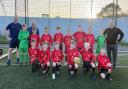 Players from Thornbury Town Football Club’s under-10s in their new season match kit with coaches