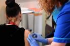 How many NHS health workers in Gloucestershire not vaccinated