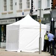 Police and forensic tents have been set up around a cafe in Gloucester where police are searching for a suspected victim of Fred West