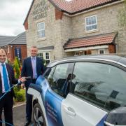 Luke Hall, MP for Thornbury and Yate, switches on the first electric vehicle charging point at Morton Meadows alongside James Dunne, MD Barratt David Wilson Homes South West