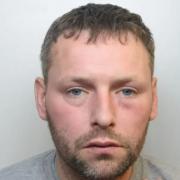 Robber with axe jailed for 12 years