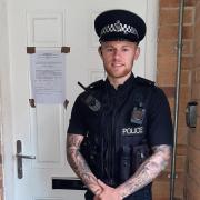 PC Dan Nash from Bristol North neighbourhood policing team outside the property in Eliot Close with the closure order