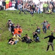 Brave competitors at the Cheese Rolling event in 2019 - photo by Simon Pizzey