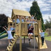 Children enjoying new play equipment recently installed on the school's grounds