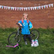 Ava Osgood with her bike, scooter and rollerblades - she has already raised more than £600 for Cancer Research UK