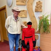 Army veteran Dave Denning with his creations George and Flanders made out of red and purple felt poppies