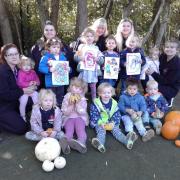 Children and staff from Little Acorns which has received a new and improved Ofsted rating