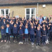 Pupils and staff from Hillesley Primary celebrating the school's recent good Ofsted report