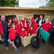 Year six pupils from Crossways Schools celebrate their new outdoor play sheds with staff members Paul Medlicott and Rhian Moore, and Miller Homes sales manager Jemma Phillips