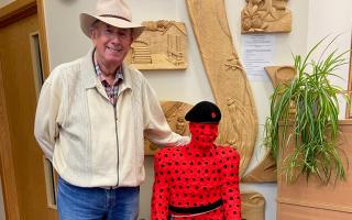 Army veteran Dave Denning with his creations George and Flanders made out of red and purple felt poppies